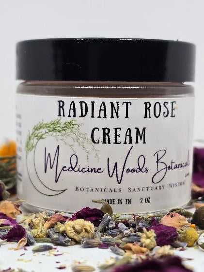 Jar of Radiant Rose Cream surrounded by dried flowers on a light background